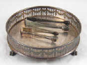 Appraisal: A silver plated circular galleried stand on three claw feet