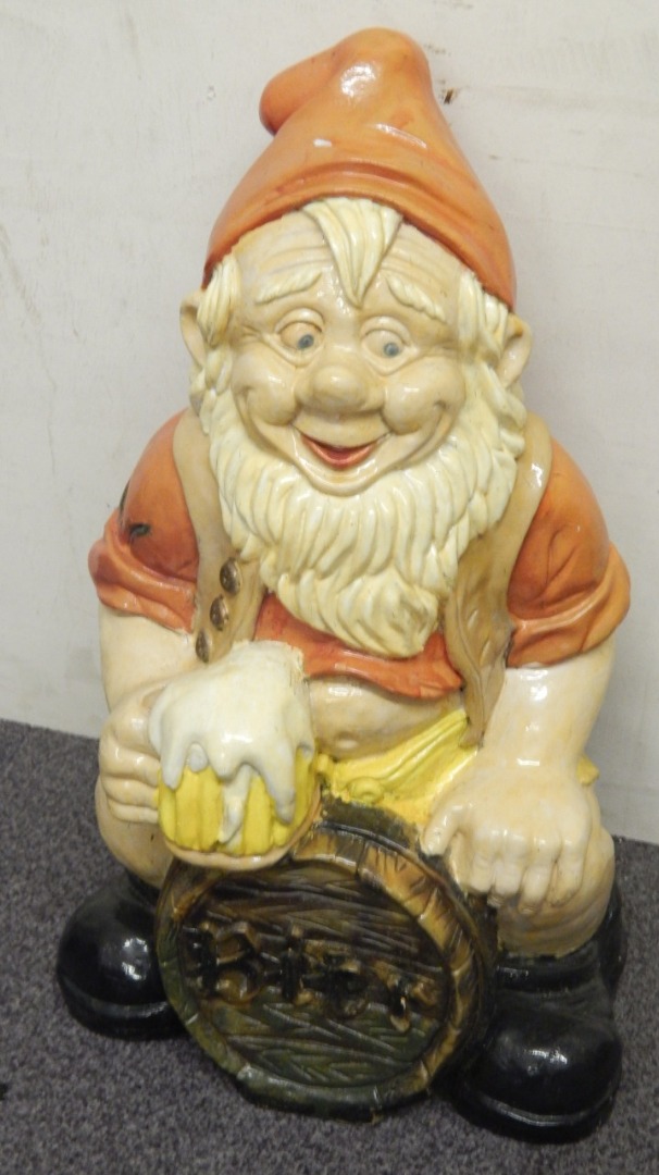 Appraisal: A large German fibreglass garden gnome seated on a barrel