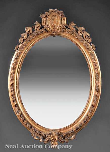 Appraisal: An Antique Louis XVI-Style Giltwood Mirror oval beaded surround surmounted