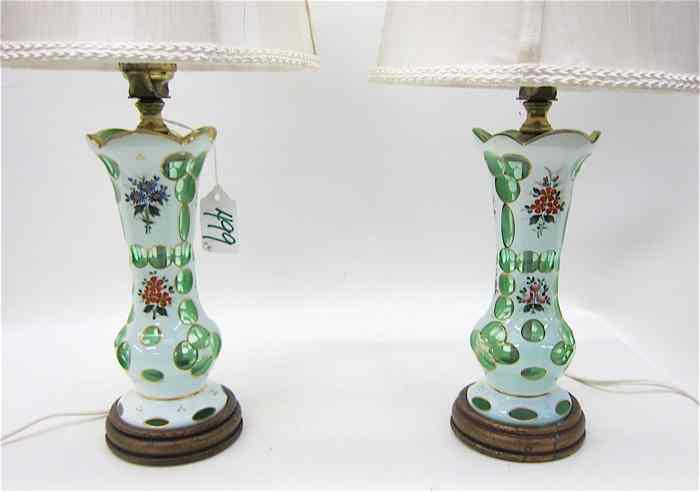 Appraisal: PAIR BOHEMIAN OVERLAY GLASS TABLE LAMPS having white exterior cut