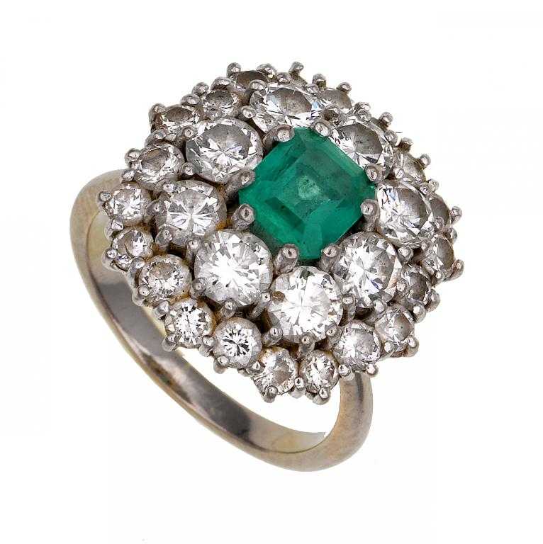 Appraisal: AN EMERALD AND DIAMOND CLUSTER RING the step cut emerald