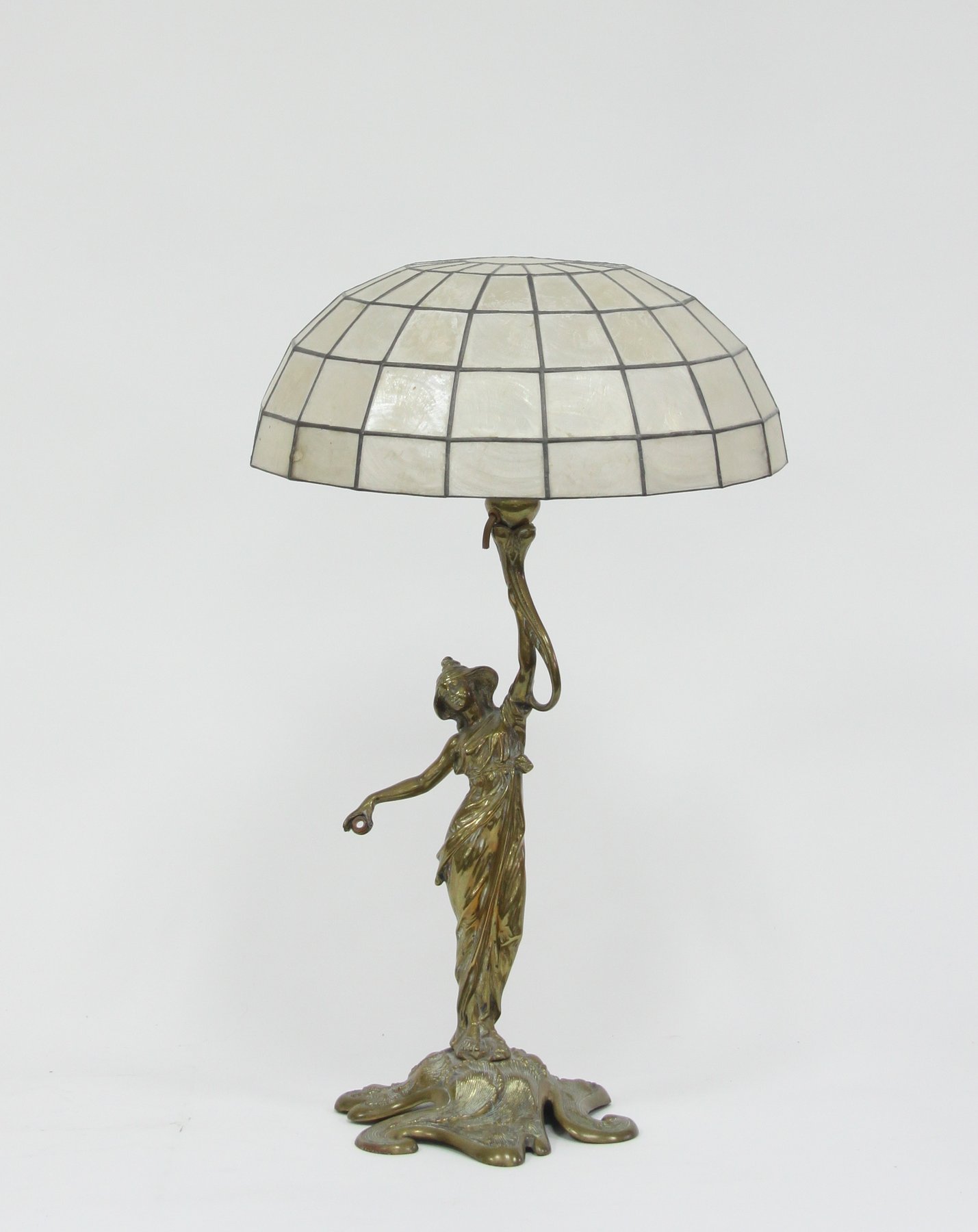 Appraisal: An Art Nouveau style figural brass lamp with shell shade