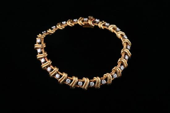 Appraisal: K YELLOW GOLD AND DIAMOND BRACELET diamonds set within braided