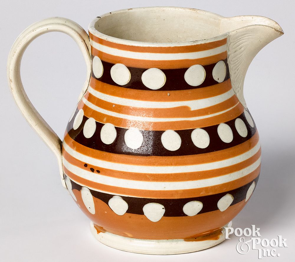 Appraisal: Mocha pitcher Mocha pitcher with tan and dotted bands h