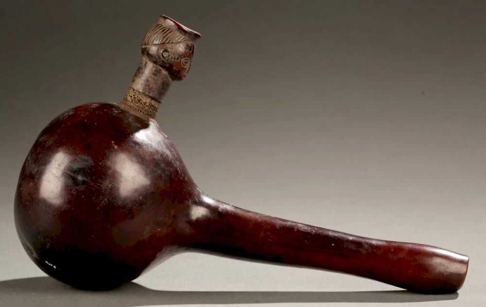 Appraisal: Nigerian gourd pipe th c A gourd pipe with wooden