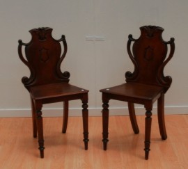 Appraisal: A pair of Victorian mahogany hall chairs