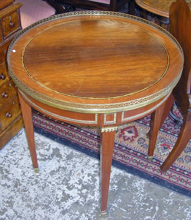 Appraisal: A French circular occasional table with raised brass gallery edge