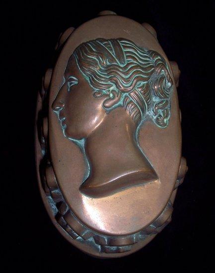 Appraisal: A copper jelly mould embossed with the young head in