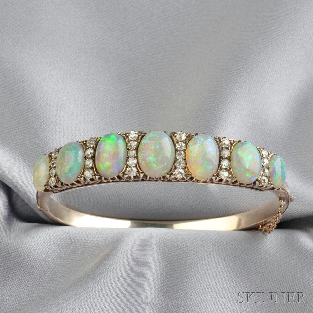 Appraisal: Gold Opal and Diamond Bracelet the hinged bangle set with