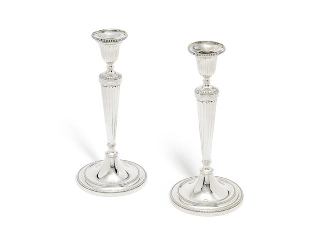 Appraisal: A pair of George III silver candlesticks by Daniel Smith