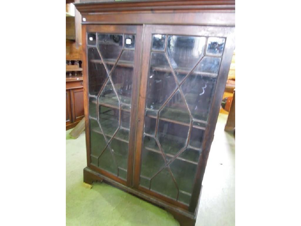 Appraisal: A Georgian mahogany bookcase enclosed by a pair of astragal