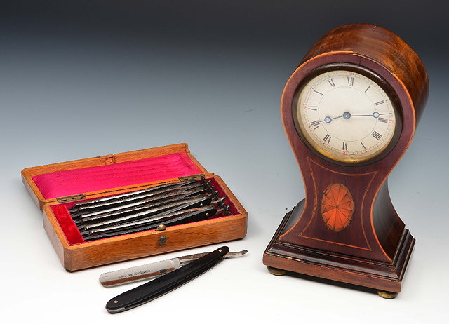 Appraisal: An Edwardian mahogany mantel clockwith waisted case with inlaid string