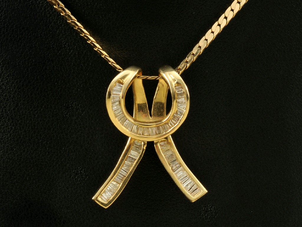 Appraisal: A Continental Diamond Pendant the calibre-cut stones channel-set in knot