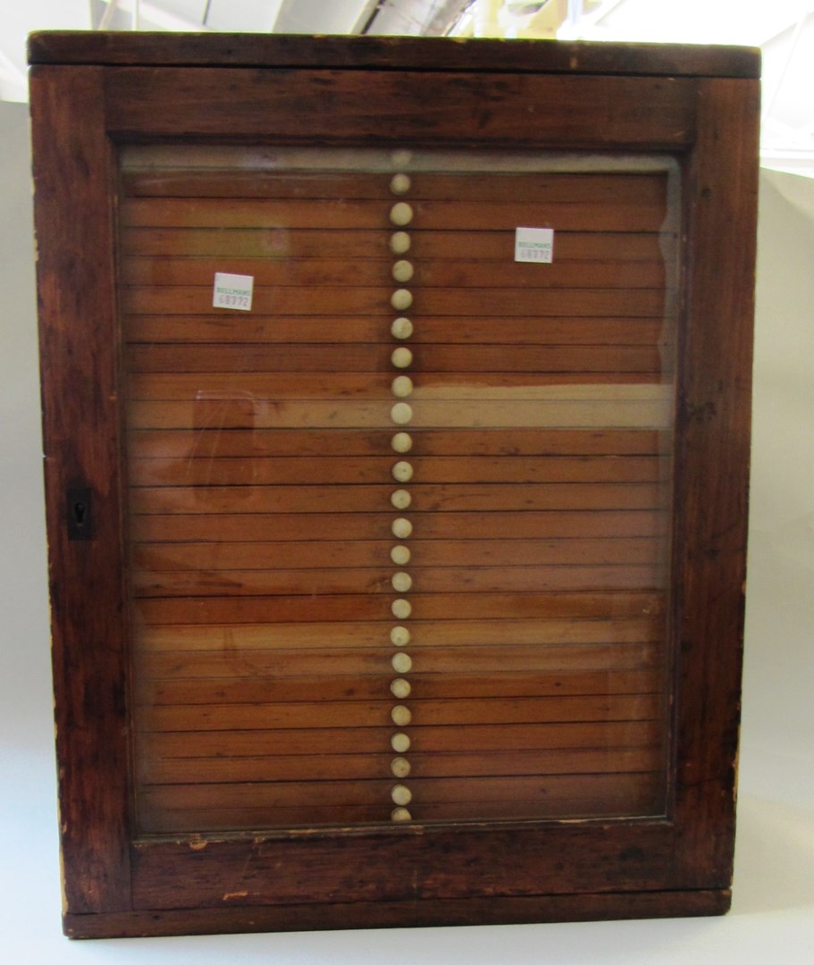 Appraisal: An early th century stained pine collectors chest with single