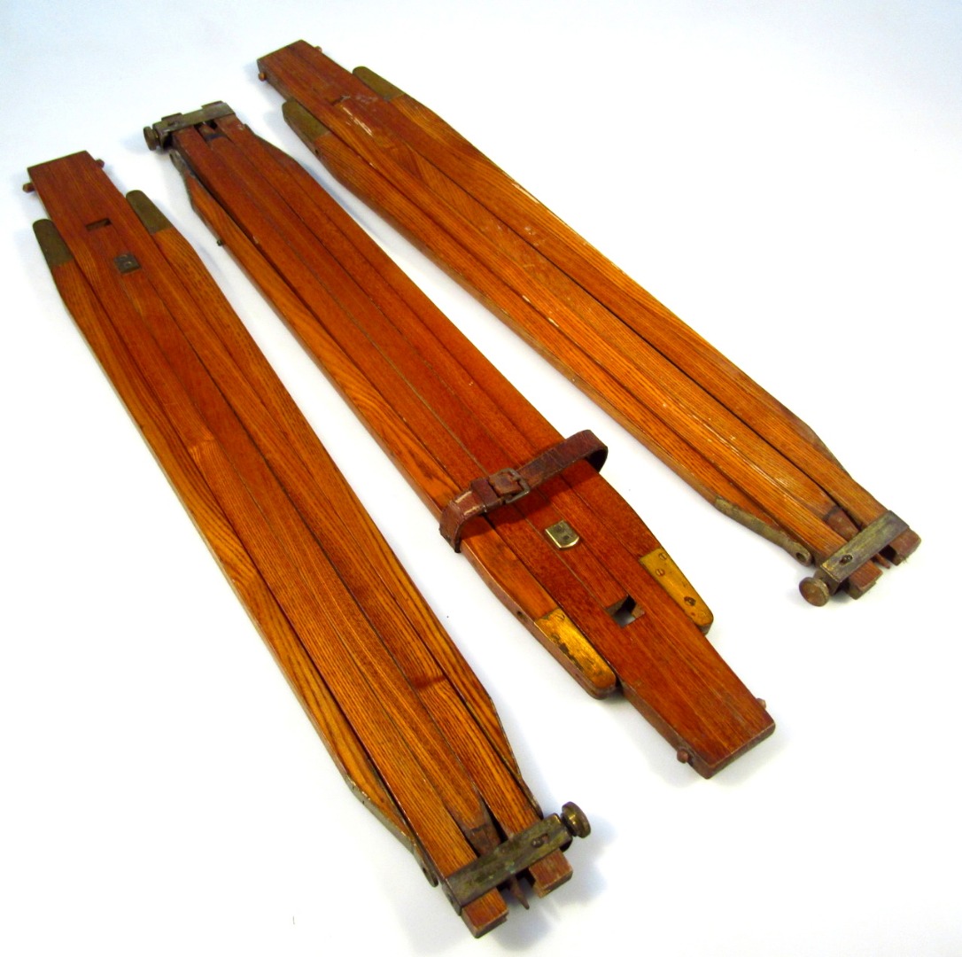 Appraisal: Three stained pine finish easel mounts with brass ends cm