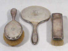 Appraisal: A three piece German silver mirror and brush set circa