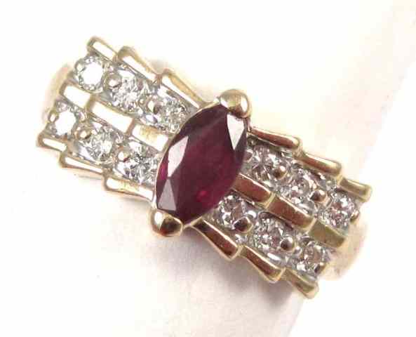 Appraisal: RUBY DIAMOND FOURTEEN KARAT GOLD RING featuring a marquise-cut ruby