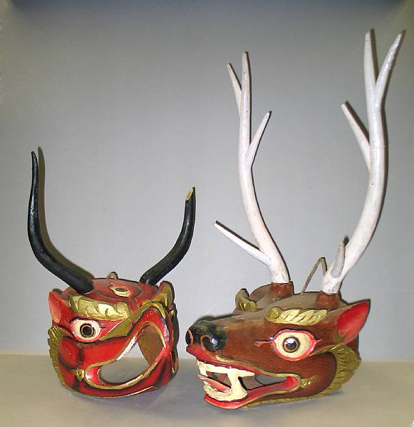 Appraisal: Two Tibetan style wood carved polychrome animals masks Including one