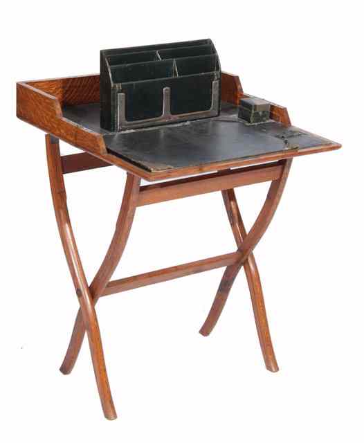 Appraisal: AN EARLY TH CENTURY OAK CAMPAIGN DESK with green leather