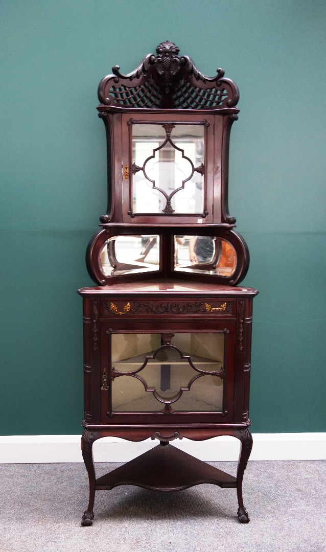 Appraisal: A late th century mahogany double height corner display cupboard