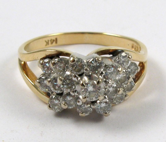 Appraisal: DIAMOND AND FOURTEEN KARAT GOLD RING set with a cluster