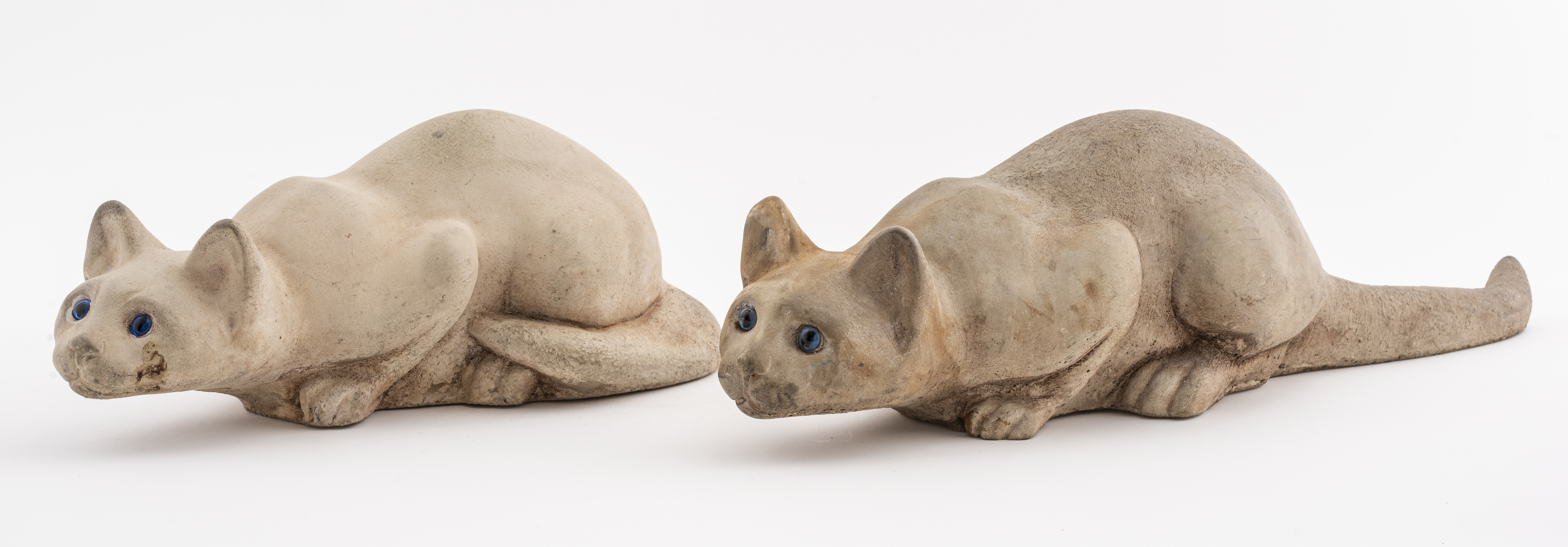 Appraisal: ENGLISH CROUCHING CONCRETE CAT FIGURES Two crouching concrete cat figures