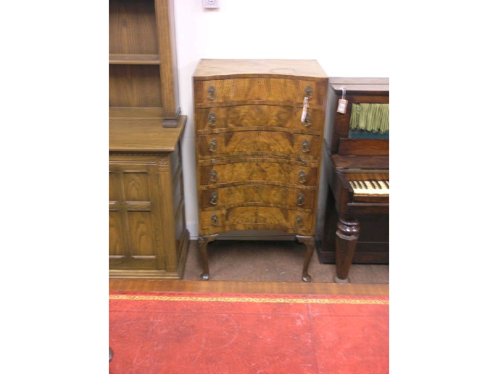 Appraisal: An Art Deco walnut tallboy concave-fronted with six drawers on