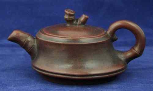 Appraisal: A small Chinese pottery teapot and cover with bamboo moulded