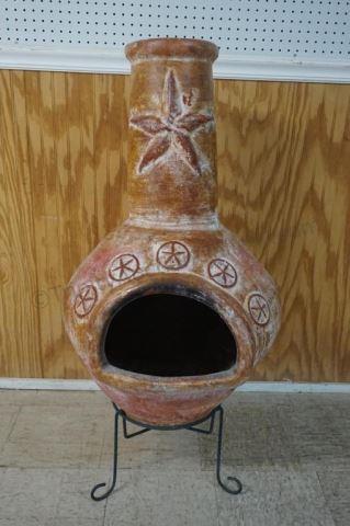 Appraisal: Fired terracotta Texas Star chiminea and metal stand The chiminea