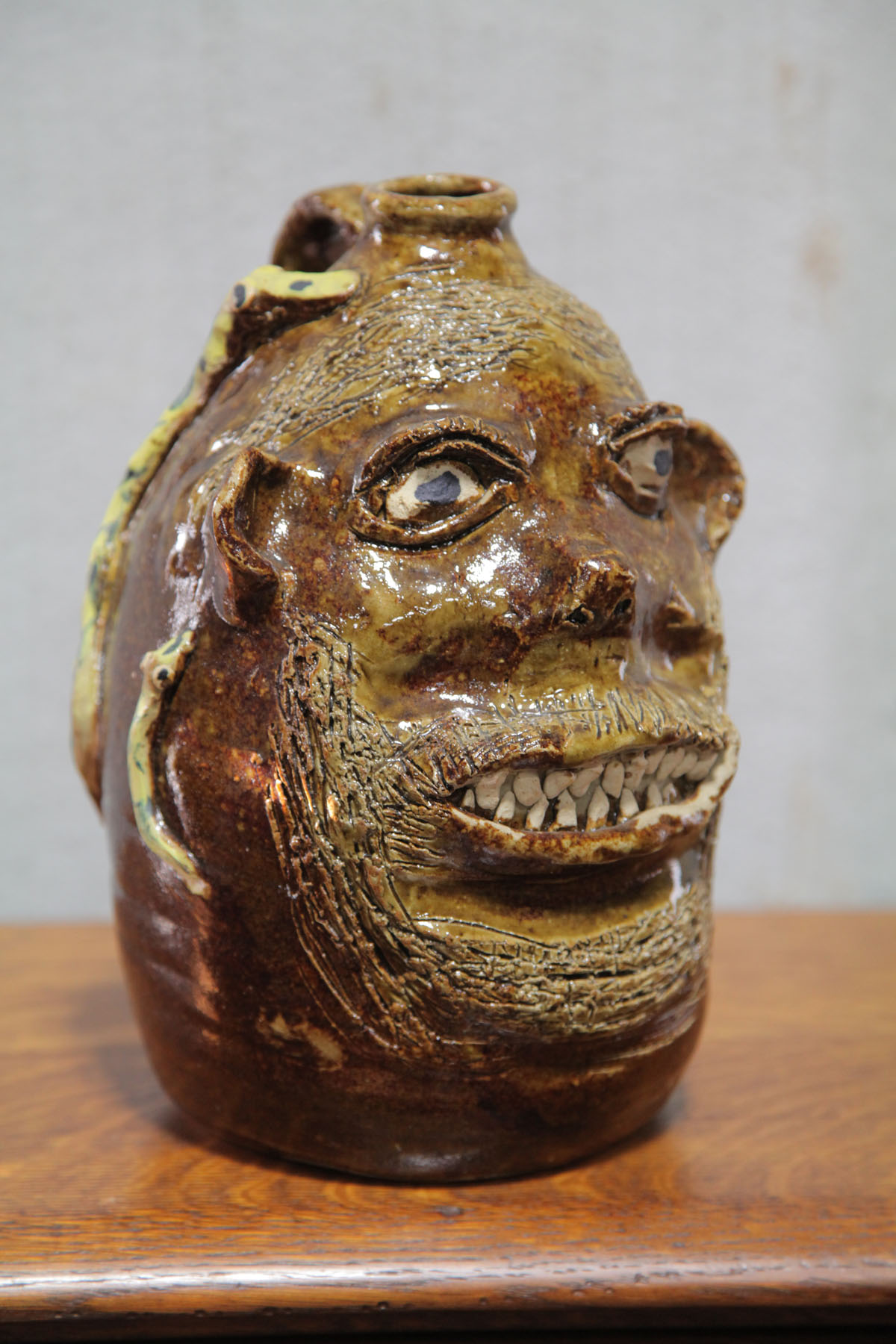 Appraisal: FACE JUG Georgia th century Grotesque face jug with applied