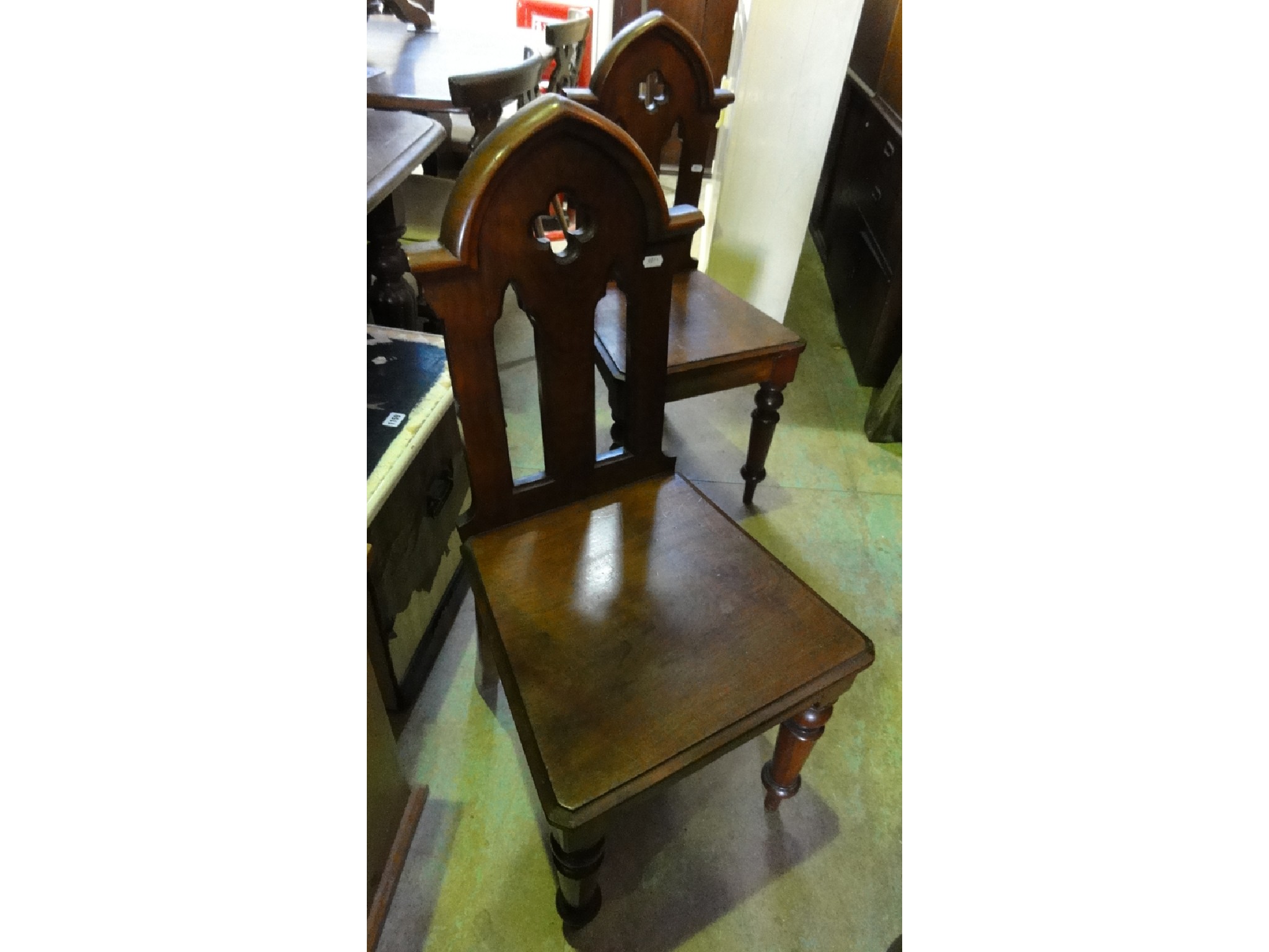 Appraisal: A pair of Victorian mahogany hall chairs with pierced gothic