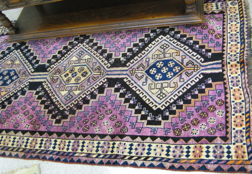 Appraisal: PERSIAN SHIRAZ AREA RUG three geometric medallion design on lavender