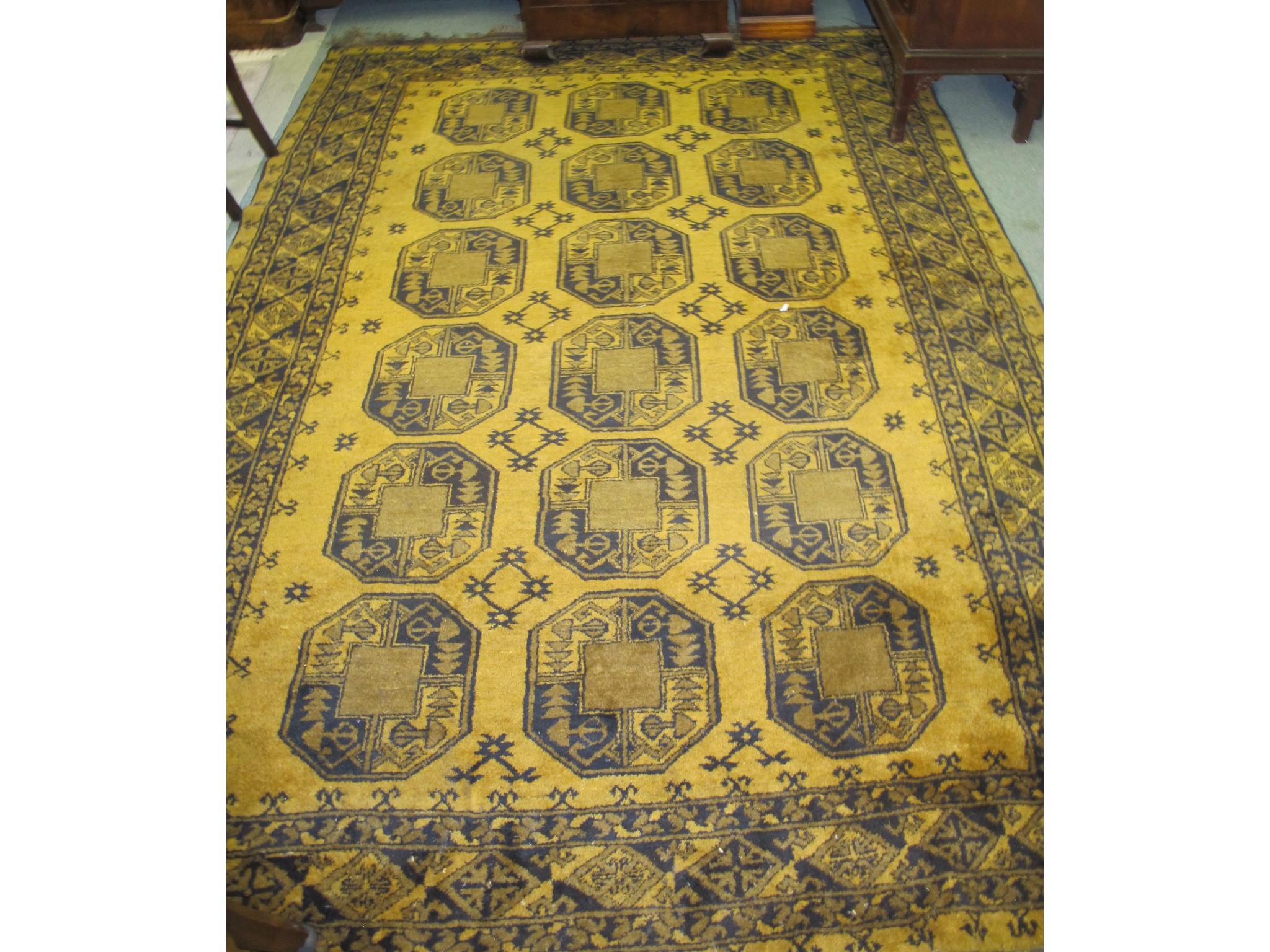 Appraisal: Eastern floor rug on a mustard and blue ground and