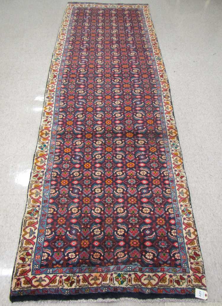 Appraisal: HAND KNOTTED PERSIAN HALL RUG overall Herati floral design on