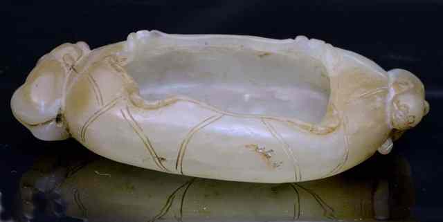 Appraisal: A CHINESE JADE OVAL WATER COUPE with scroll decoration the