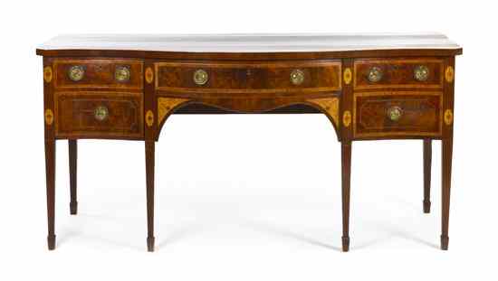 Appraisal: A Sheraton Style Mahogany Sideboard having a serpentine top over