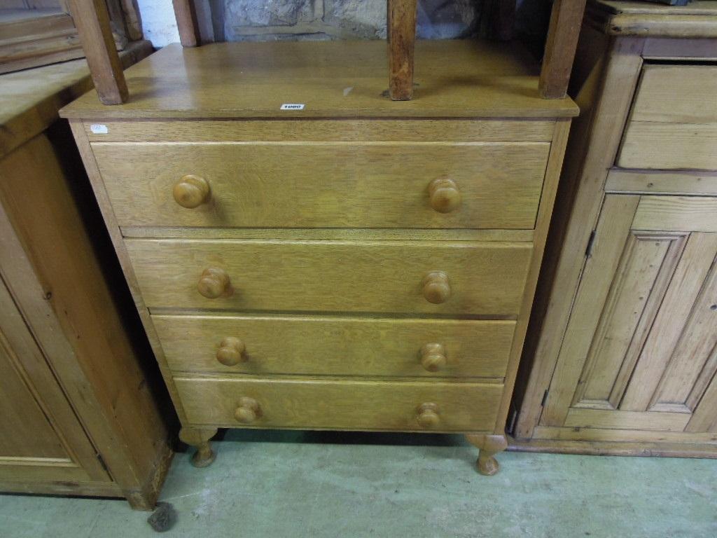 Appraisal: A stripped oak chest fitted with four long drawers raised