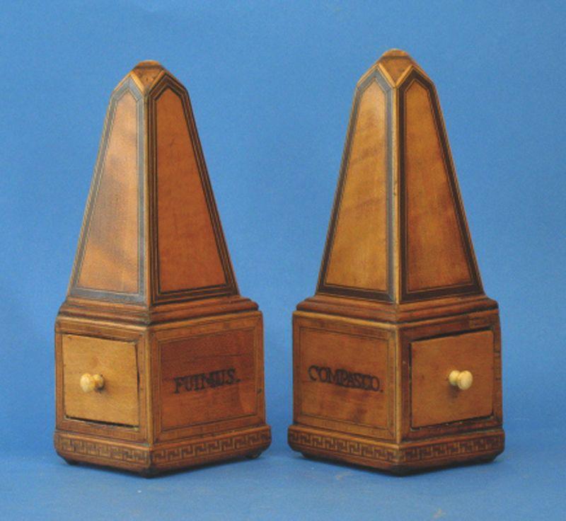 Appraisal: A PAIR OF SATINWOOD AND ROSEWOOD VENEERED OBELISKS each containing