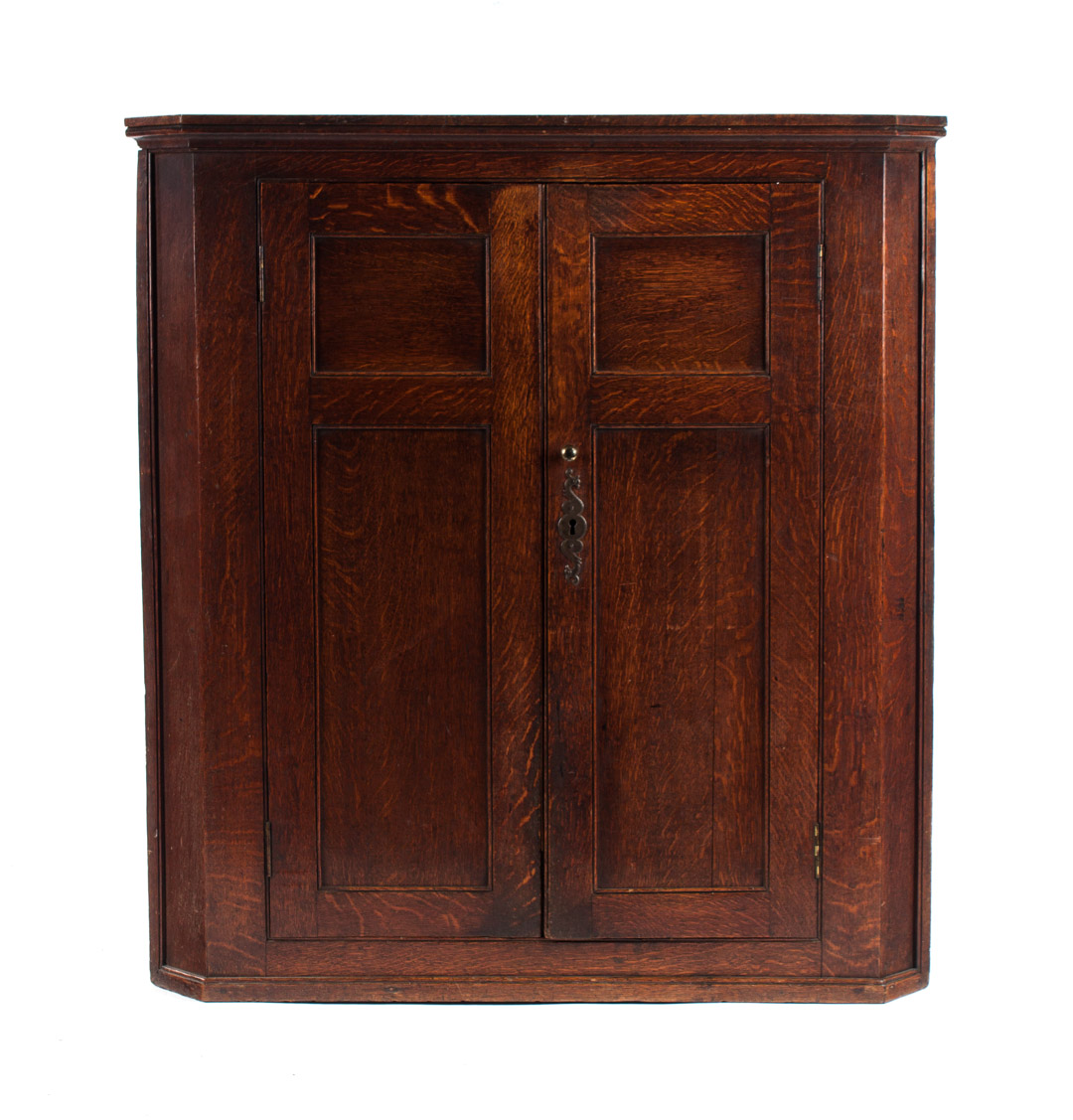 Appraisal: English vernacular oak hanging corner cupboard th th century flat