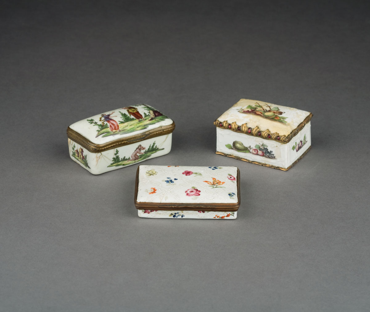 Appraisal: THREE ENGLISH AND CONTINENTAL ENAMEL WHITE-GROUND BOXES NINETEENTH CENTURY The