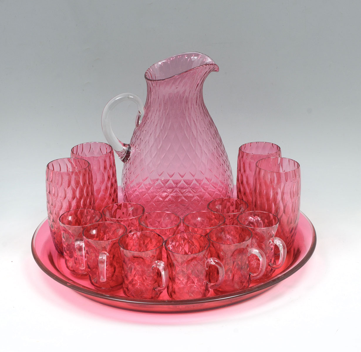 Appraisal: CRANBERRY PITCHER GLASS SET ON TRAY Blown glass Victorian Cranberry