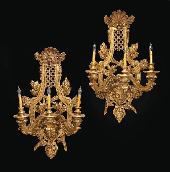 Appraisal: A pair of Continental Baroque style giltwood three light wall