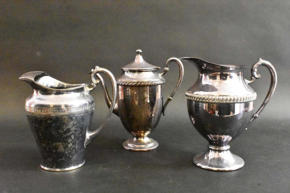 Appraisal: THREE SILVER PLATE PITCHERSCirca go All marked one impressed Rogers