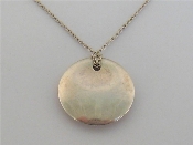 Appraisal: Tiffany Elsa Peretti Collection a silver disc pendant signed and