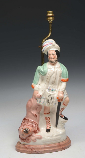 Appraisal: A STAFFORDSHIRE POTTERY FIGURE of a 'Lion Slayer' set up