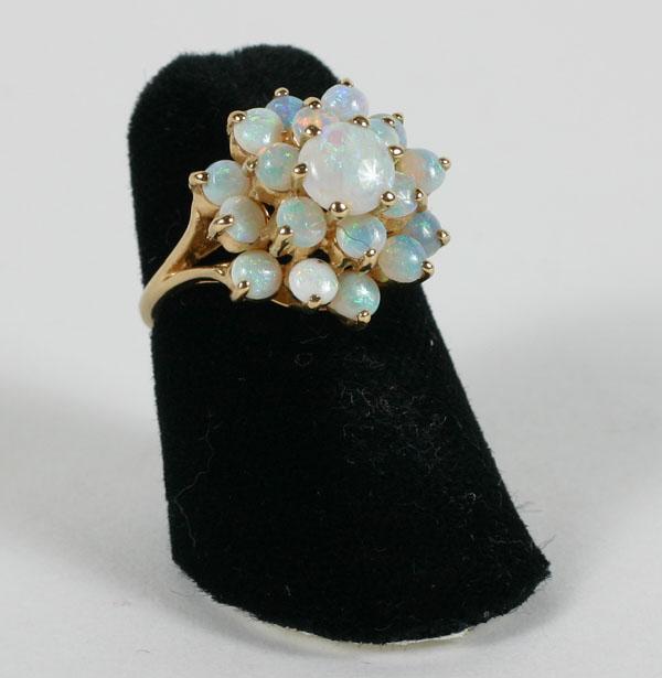 Appraisal: Yellow gold K split shank tiered white opal cathedral ring