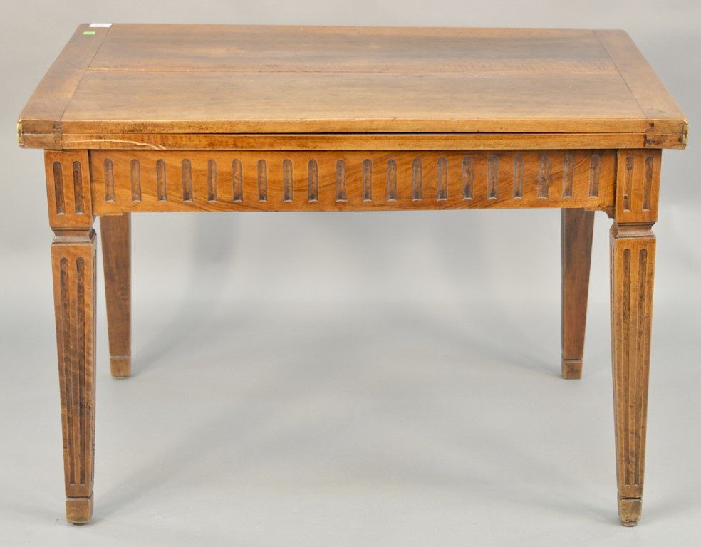 Appraisal: Walnut folding table having hinged top on fluted legs Provenance