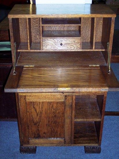 Appraisal: An oak fall front desk the interior fitted pigeon holes