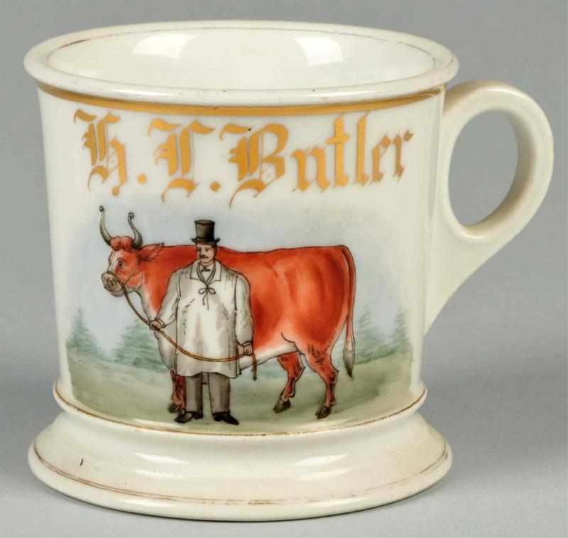 Appraisal: Man with Top Hat Prize Steer Shaving Mug Description Gilt