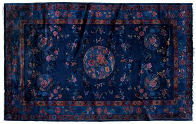 Appraisal: Chinese rug repeating coin and floral designs on dark blue